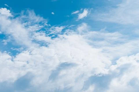Blue clear sky with fluffy clouds. Big clouds floating in blue sky. Natural w Stock Photos
