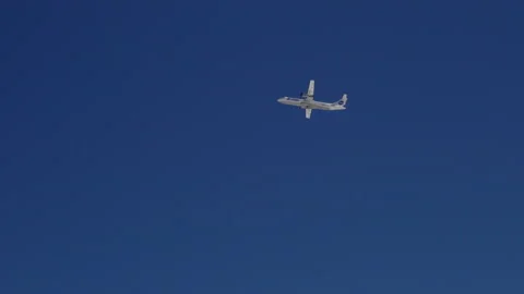 In the blue clear sky, a plane taking off is gaining altitude Stock Footage 151087262