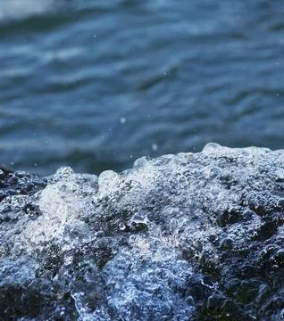 Blue clear Waterfall and bubbles on a lake Stock Photos