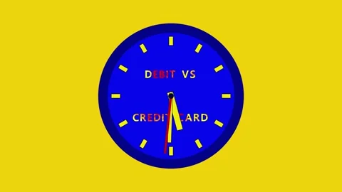 A blue clock with Debit vs Credit Card on its face and moving hands sits on a Stock Footage 332595987