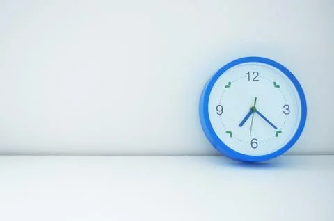 Blue clock on wall Stock Photos