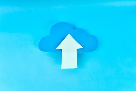 Blue cloud with white upload arrow on blue background for cloud storage 写真素材