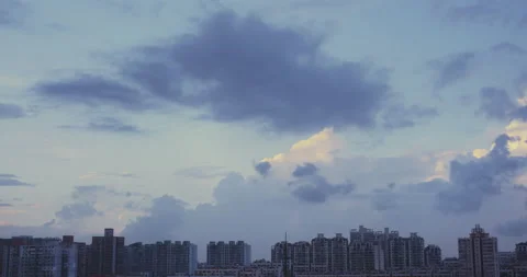 Blue clouds in the sky and buildings in the distance Stock Footage 162774064