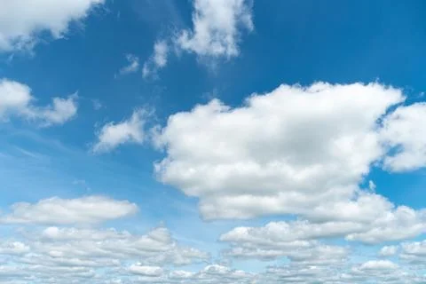 Blue clouds in the sky. Warm sunny day. Stock Photos