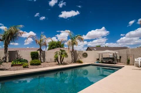 Blue cloudy sky and pool vacation Stock Photos