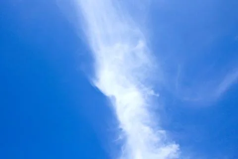 Blue cloudy sky with clouds unusual shapes. Stock Photos