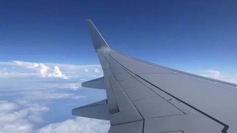 Blue cloudy sky view from the airplane window in UHD Video stock 116588962