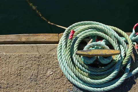Blue coiled rope in the dock Stock Photos