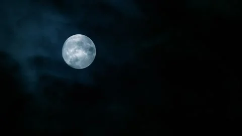 Blue cold full moon in the cloudy evening sky Stock Footage 254287627