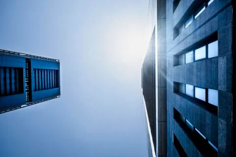 Blue cold tones colors of skyscrapers with sunlight - looking up perspective, Stock Photos