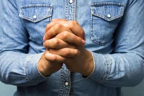 Blue collar worker with hands folded Foto stock