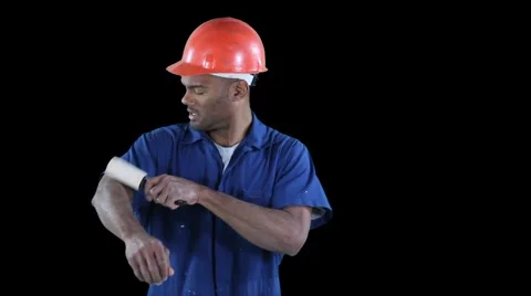 Blue collar worker start cleaning his jump suit with roller - frustrated Stock Footage