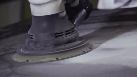 Blue collar Worker uses sander tool on rough surface Stockbeeldmateriaal 112008236