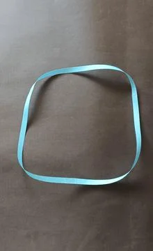 Blue color different shape mobius strip or band isolated on brown background Foto stock