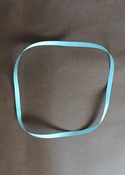 Blue color different shape mobius strip or band isolated on brown background 스톡 사진