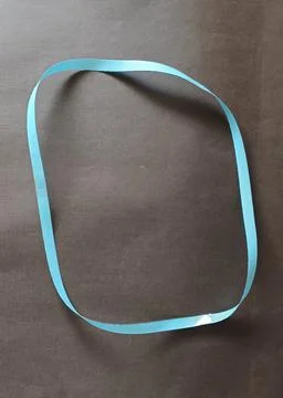 Blue color different shape mobius strip or band isolated on brown background Stock Photos