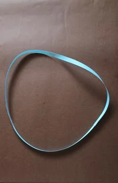Blue color different shape mobius strip or band isolated on brown background 스톡 사진