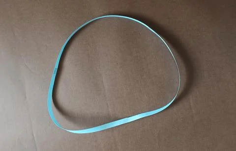 Blue color different shape mobius strip or band isolated on brown background Stock Photos
