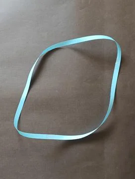 Blue color different shape mobius strip or band isolated on brown background Stock Photos
