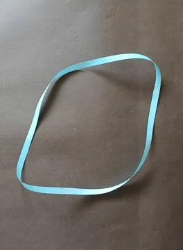 Blue color different shape mobius strip or band isolated on brown background 스톡 사진