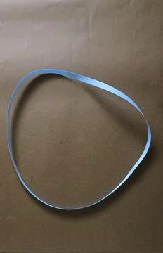 Blue color different shape mobius strip or band isolated on brown background Stock Photos