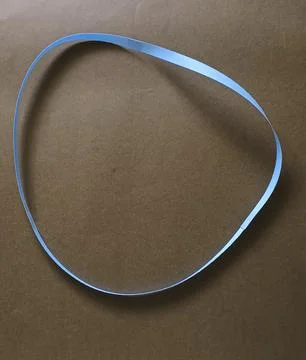 Blue color different shape mobius strip or band isolated on brown background Foto stock