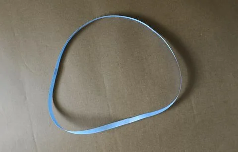 Blue color different shape mobius strip or band isolated on brown background 스톡 사진