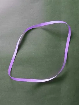Blue color different shape mobius strip or band isolated on brown background Stock Photos