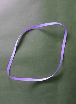 Blue color different shape mobius strip or band isolated on brown background 스톡 사진