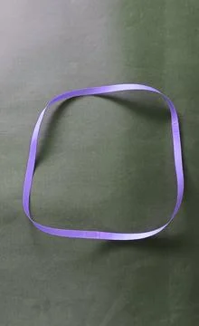 Blue color different shape mobius strip or band isolated on brown background Stock Photos