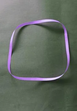 Blue color different shape mobius strip or band isolated on brown background Stockfoto's