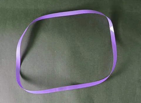 Blue color different shape mobius strip or band isolated on brown background Foto stock