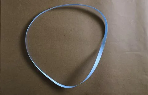 Blue color different shape mobius strip or band isolated on brown background Foto stock