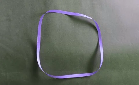 Blue color different shape mobius strip or band isolated on brown background Stock Photos