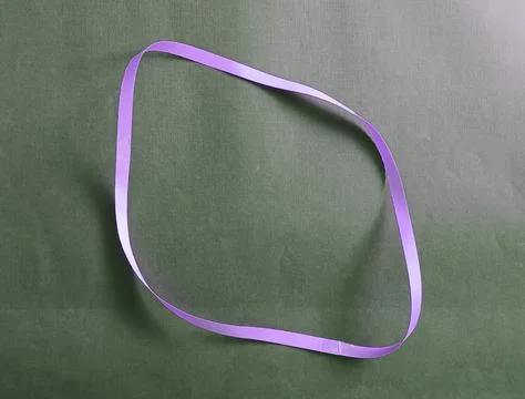 Blue color different shape mobius strip or band isolated on brown background Stockfoto's