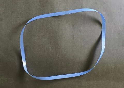 Blue color different shape mobius strip or band isolated on brown background 스톡 사진