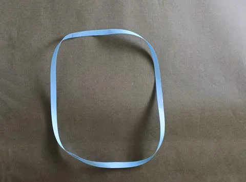 Blue color different shape mobius strip or band isolated on brown background Stock Photos