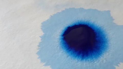Blue color inks spreading out over wet paper background Stock Footage 277960799