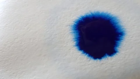 Blue color inks spreading out over wet paper background Stock Footage 277960812