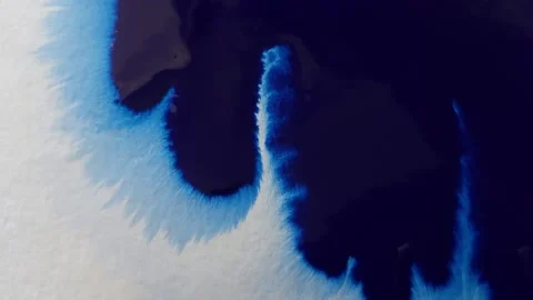 Blue color inks spreading out over wet paper background Stock Footage 277960823