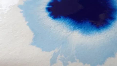 Blue color inks spreading out over wet paper background Video stock 277960825