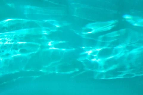 Blue colored abstract background with light and shadows caustic effect Stock Photos
