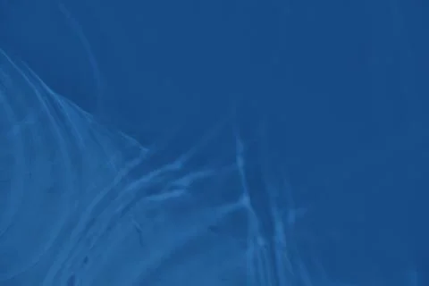 Blue colored abstract background with light and shadows caustic effect Stock Photos