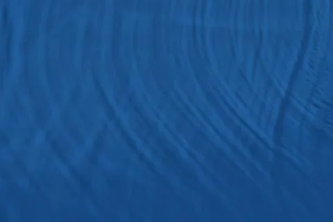 Blue colored abstract background with light and shadows caustic effect Foto stock