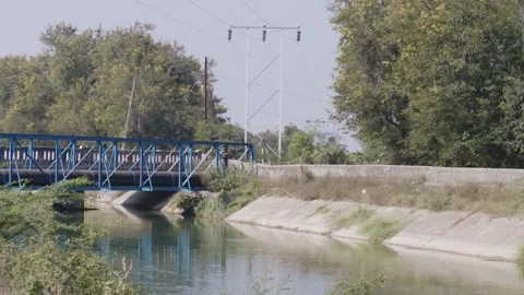 Blue-colored bridge over a canal Stock Footage 281280093