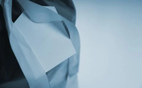 Blue colored close up of Empty Greeting card with ribbon on gift box with cop Stock Photos