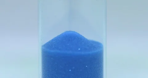 Blue Colored Hourglass extremely closeup Stock Footage 117410246