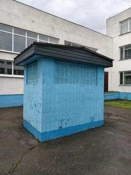Blue concrete technical facility adjacent to a Soviet era school building, .. Stock Photos