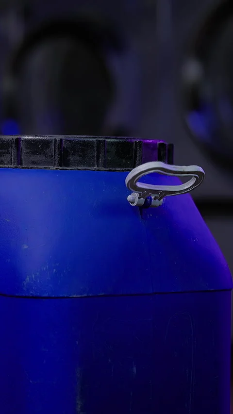 Blue container with a metal lid on a dark background in a indoor space Stock Footage 331679959