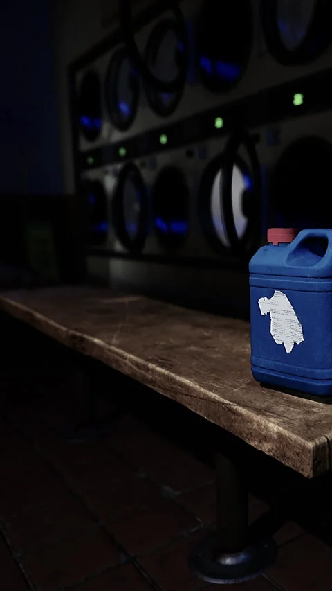 A blue container rests on a wooden bench in a laundry space Stock Footage 340646606